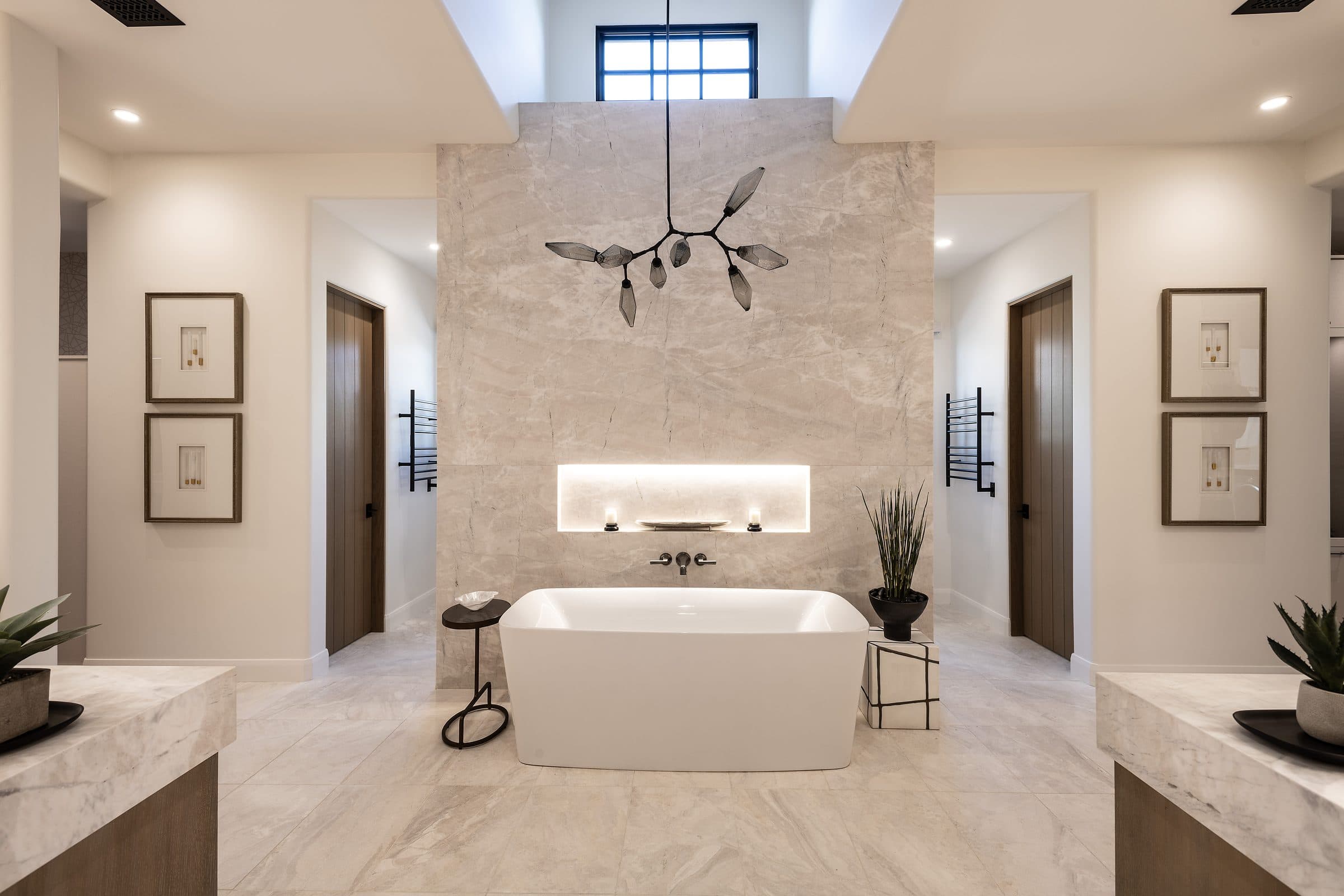 Freestanding soaking tub in a Mirabel Desert Modern bathroom by Apollo Builders